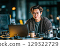 Young asian developer coding on laptop in modern office environment cheerfully 129322729