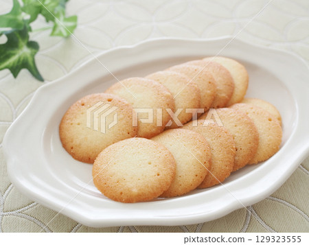 Homemade langue de chat cookies on a white plate 129323555
