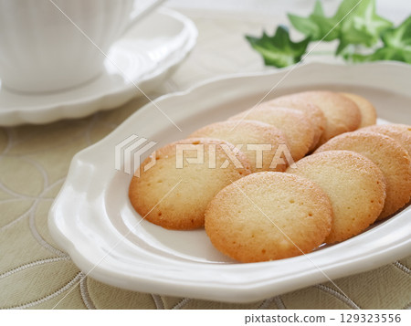 Homemade langue de chat cookies on a white plate 129323556