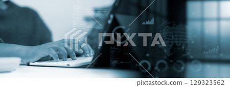 Smart business technology. Professional hands typing on keyboard in blue digital office with futuristic transparent interface showing charts, data analytics, and global map. Smart business technology. Professional hands typing on keyboard in blue digital office with futuristic transparent interface showing charts, data analytics, and global map. 129323562