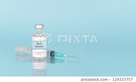 BCG vaccine vial bottle with syringe on blue background. BCG vaccine used to used to prevent tuberculosis (TB), especially in infants and young children. 129323757