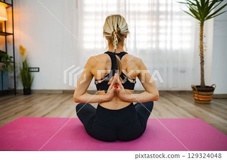 Mindful moments captured in serene indoor yoga practice 129324048