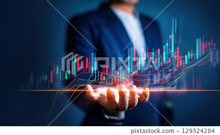 business professional holding digital stock market graph with candlestick chart 129324284