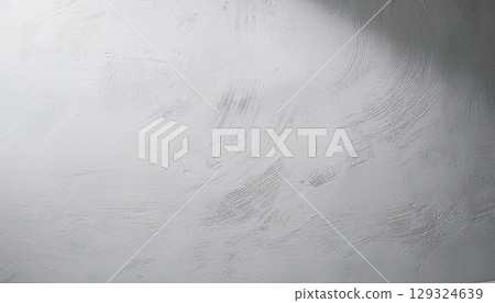 Textured concrete surface with subtle patterns and shadows, creating serene atmosphere 129324639