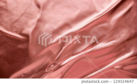 Shimmering rose gold foil texture background with soft reflections, elegant and luxurious feel 129324647