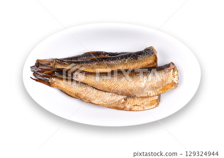 Smoked sprats in vegetable oil, in oval white bowl. Canned smoked European sprats in oil. Sprattus sprattus, small saltwater fish, also known as Baltic herring, brisling sardine, skipper or whitebait. Smoked sprats in vegetable oil, in oval white bowl. Canned smoked European sprats in oil. Sprattus sprattus, small saltwater fish, also known as Baltic herring, brisling sardine, skipper or whitebait. 129324944