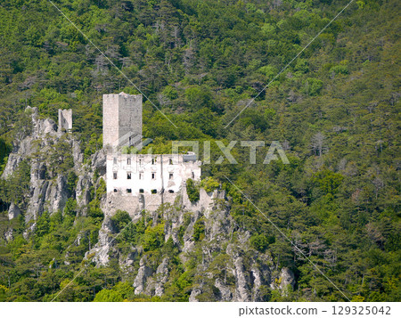 Medieval Castle Burgruine Rauhenstein in Baden, Austria in Alpine Forest - Scenic Ruins on Rocky Cliff 129325042