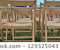 Empty chairs in a marquee 129325043