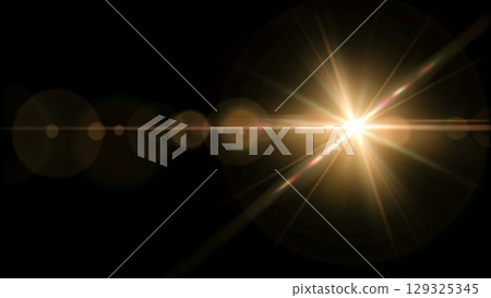 A bright light flare with multiple rays and circular lens flares on a black background 129325345