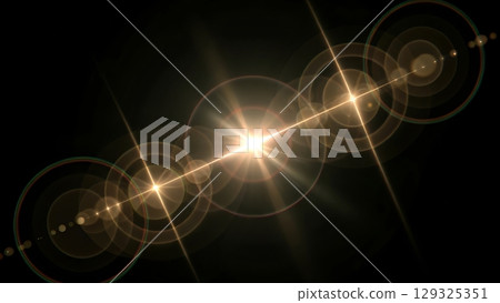 A bright light with lens flares and concentric circles against a dark background 129325351