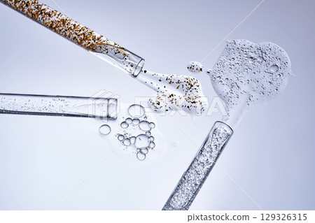 Three test tubes with spilled serums. Demonstration of textures. 129326315