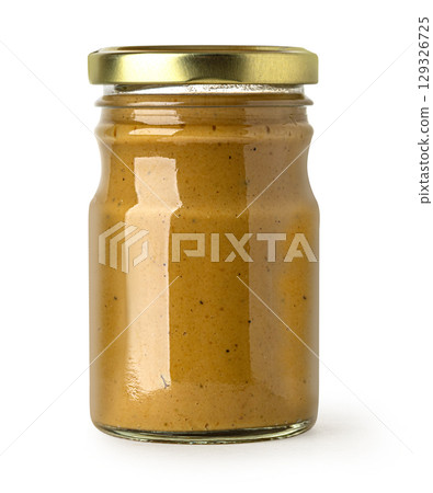 Glass jar containing mustard with gold lid on white background Glass jar containing mustard with gold lid on white background 129326725