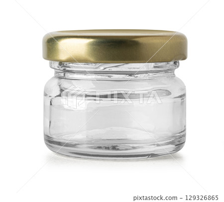 Small empty glass jar with golden lid isolated on white background Small empty glass jar with golden lid isolated on white background 129326865