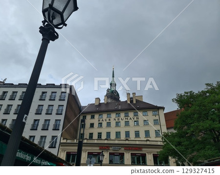 Munich, Germany - July 28, 2025: Exterior facade of the Haus Neumayr. The Hotel Neumayr overlooks the Viktualienmarkt, a food market and a square in the center of the Bavarian capital 129327415