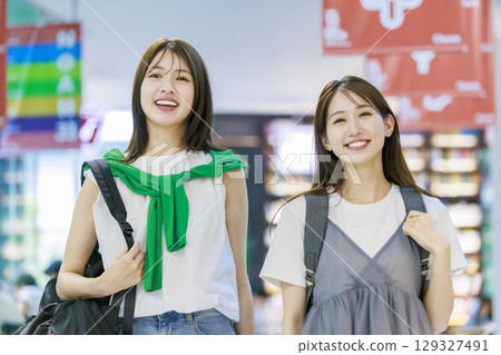 A female college student climbing the stairs on campus with her friends 129327491