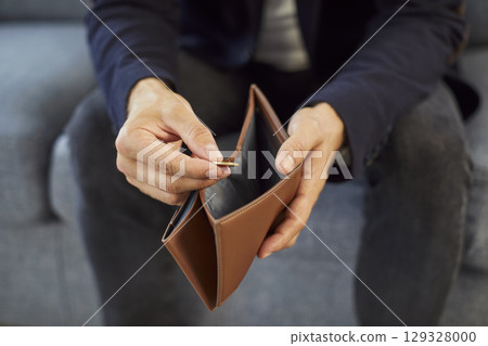 Hands of poor man counting cash money, lonely person holding open empty wallet and sitting Hands of poor man counting cash money, lonely person holding open empty wallet and sitting 129328000