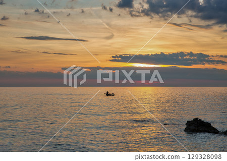 Boat on calm sea during Istrian sunset Boat on calm sea during Istrian sunset 129328098