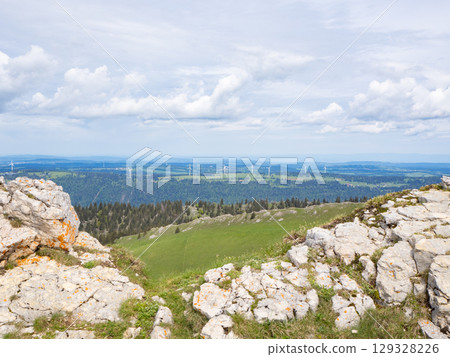 Chasseral, Switzerland - May 26th 2024: View from the summit ridge towards Mont Crosin with wind engines Chasseral, Switzerland - May 26th 2024: View from the summit ridge towards Mont Crosin with wind engines 129328226