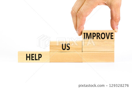 Help us improve symbol. Concept words Help us improve on beautiful wooden blocks. Beautiful white table white background. Businessman hand. Business motivational help us improve concept. Copy space. 129328276