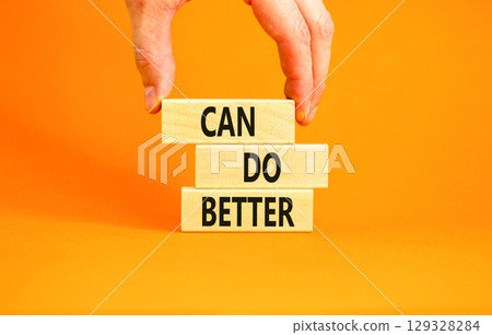 Can do better symbol. Concept words Can do better on beautiful wooden block. Businessman's hand. Beautiful orange background. Business and can do better concept. Copy space. Can do better symbol. Concept words Can do better on beautiful wooden block. Businessman's hand. Beautiful orange background. Business and can do better concept. Copy space. 129328284