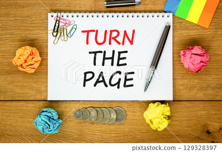 Turn the page symbol. Concept words Turn the page on beautiful white note. Black pen. Colored paper. Beautiful wooden background. Business motivational lifestyle turn the page concept. Copy space. 129328397