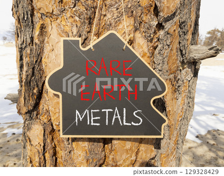 Rare earth metals symbol. Concept words Rare earth metals on beautiful blackboard. Beautiful old tree and sand beach background. Business and rare earth metals concept. Copy space. Rare earth metals symbol. Concept words Rare earth metals on beautiful blackboard. Beautiful old tree and sand beach background. Business and rare earth metals concept. Copy space. 129328429