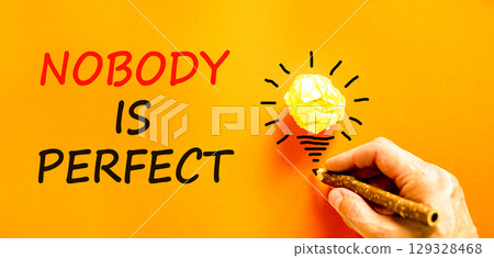 Nobody is perfect symbol. Concept words Nobody is perfect. Beautiful orange background. Businessman hand with pencil. Business motivational lifestyle nobody is perfect concept. Copy space. 129328468