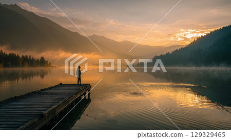 A lone fisherman on a wooden pier at dawn, a peaceful mountain lake scene A lone fisherman on a wooden pier at dawn, a peaceful mountain lake scene 129329465