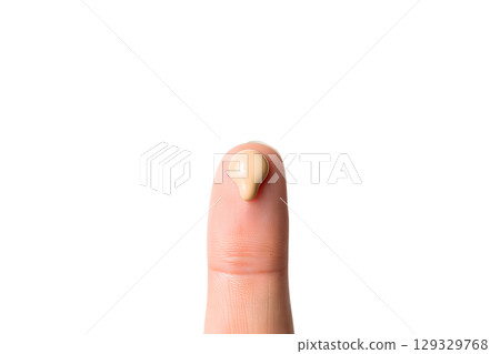 Close-up of fingertip testing liquid foundation, beauty product texture showcase 129329768