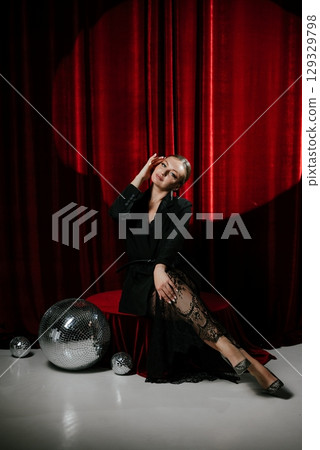 Elegant Woman Posing with Disco Balls in Luxurious Setting Elegant Woman Posing with Disco Balls in Luxurious Setting 129329798