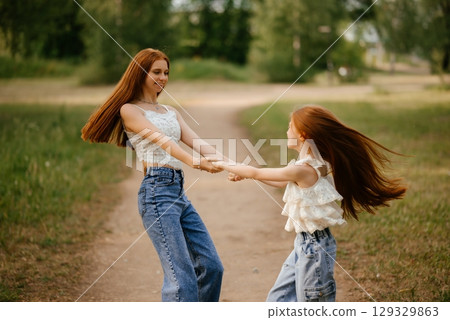 Joyful Dance in Nature Between Two Girls 129329863