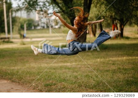 Energetic Leap in Park Captures Joyful Movement Outdoors 129329869