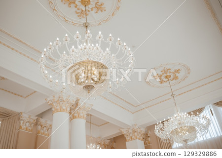 Elegant Crystal Chandeliers Adorning a Luxurious Hall Elegant Crystal Chandeliers Adorning a Luxurious Hall 129329886