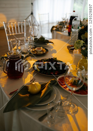 Elegant Dining Table Setup with Plates and Glassware 129329897