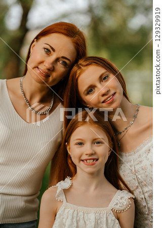 Happy Family Outdoor Portrait with Smiling Faces 129329919
