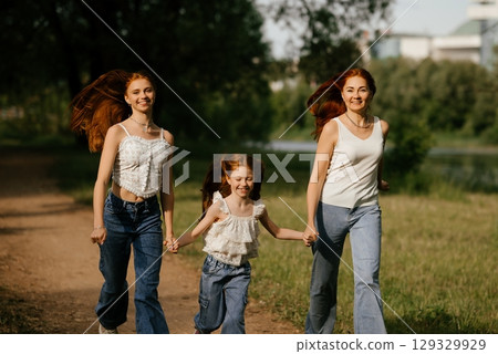 Three Women Joyfully Walking in Nature 129329929