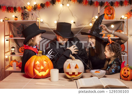 Happy Halloween family party, pumpkin lantern decor, parents and kids fun gather at home  129330103