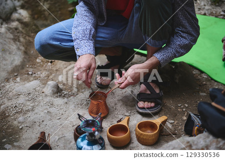 Outdoor Cooking Scene Showcasing Traditional Methods in a Natural Setting 129330536