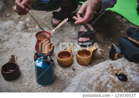 Outdoor Coffee Preparation Using Traditional Copper Pot and Camping Gear Outdoor Coffee Preparation Using Traditional Copper Pot and Camping Gear 129330537