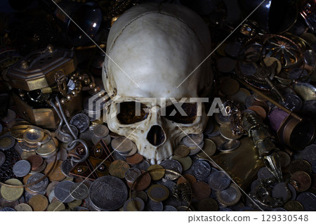 Skull among treasure coins and jewellery. Skull among treasure coins and jewellery. 129330548