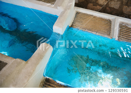 Clear Blue Water in a Traditional Stone Washing Basin Clear Blue Water in a Traditional Stone Washing Basin 129330591