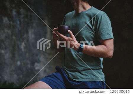 Man Drinking Outdoors Wearing Casual Clothing and Fitness Tracker Man Drinking Outdoors Wearing Casual Clothing and Fitness Tracker 129330615