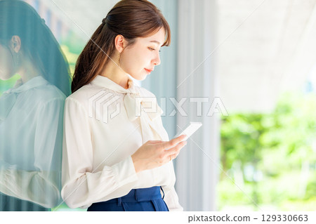 Business woman using a smartphone Business woman using a smartphone 129330663