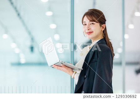 Business woman with laptop Business woman with laptop 129330692