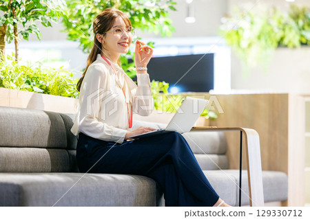 Woman working in coworking space Woman working in coworking space 129330712