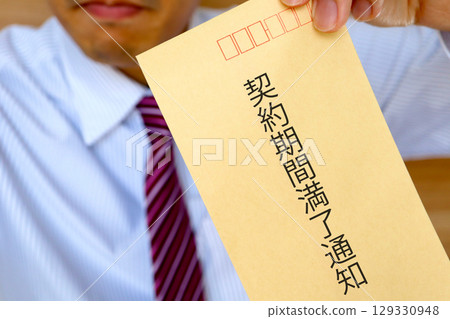 Image of a businessman holding a contract expiration notice Image of a businessman holding a contract expiration notice 129330948