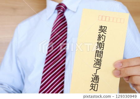 Image of a businessman holding a contract expiration notice Image of a businessman holding a contract expiration notice 129330949