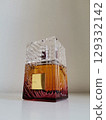 Textured glass perfume bottle on white background 129332142