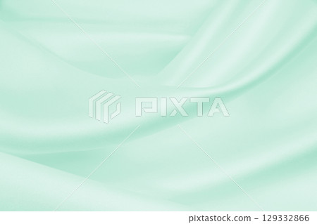Smooth elegant green silk or satin luxury cloth texture as abstract background. Luxurious background design 129332866