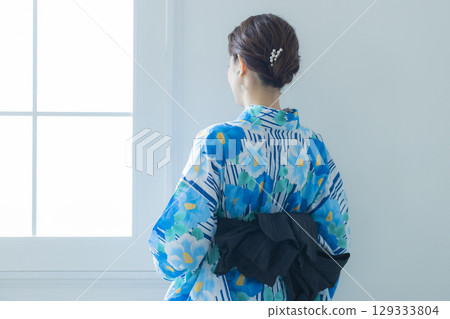 A woman in a yukata by the window A woman in a yukata by the window 129333804